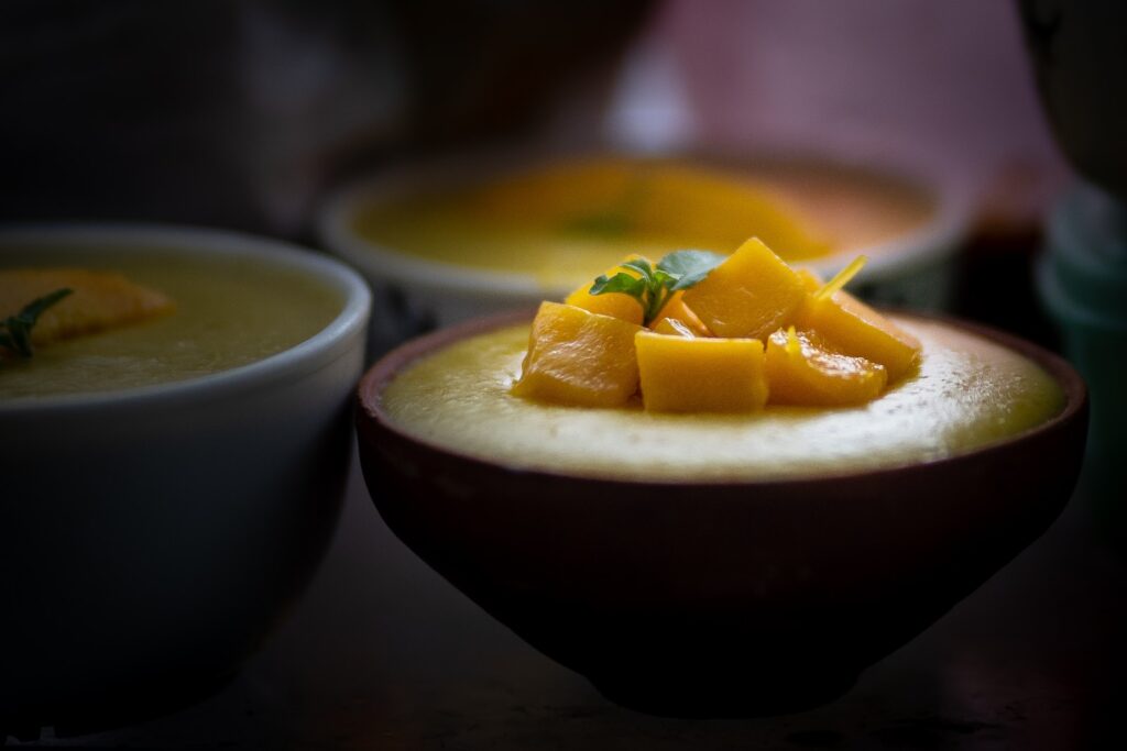 sliced orange fruit on blue ceramic bowl